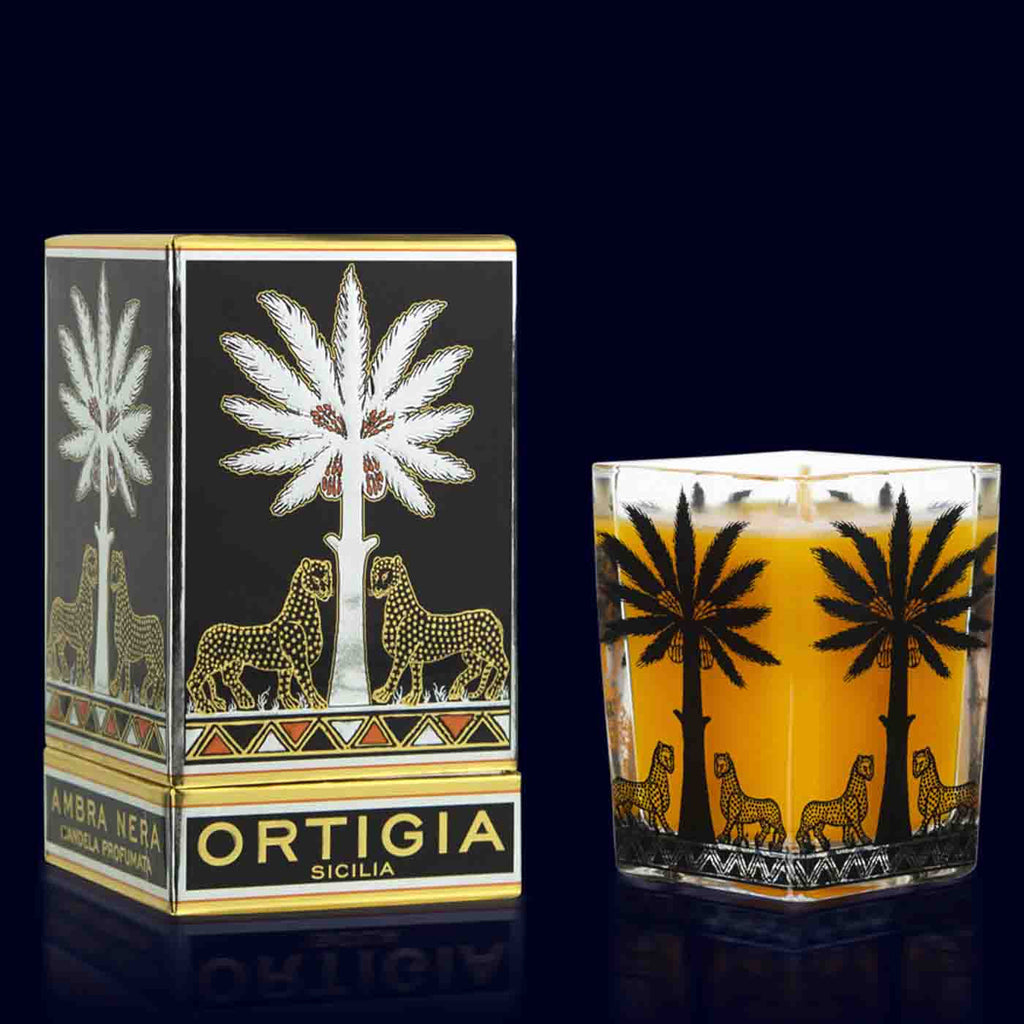 ortigia ambra nera candle in a square vessel with black printed palmtrees in a square box black, gold and silver