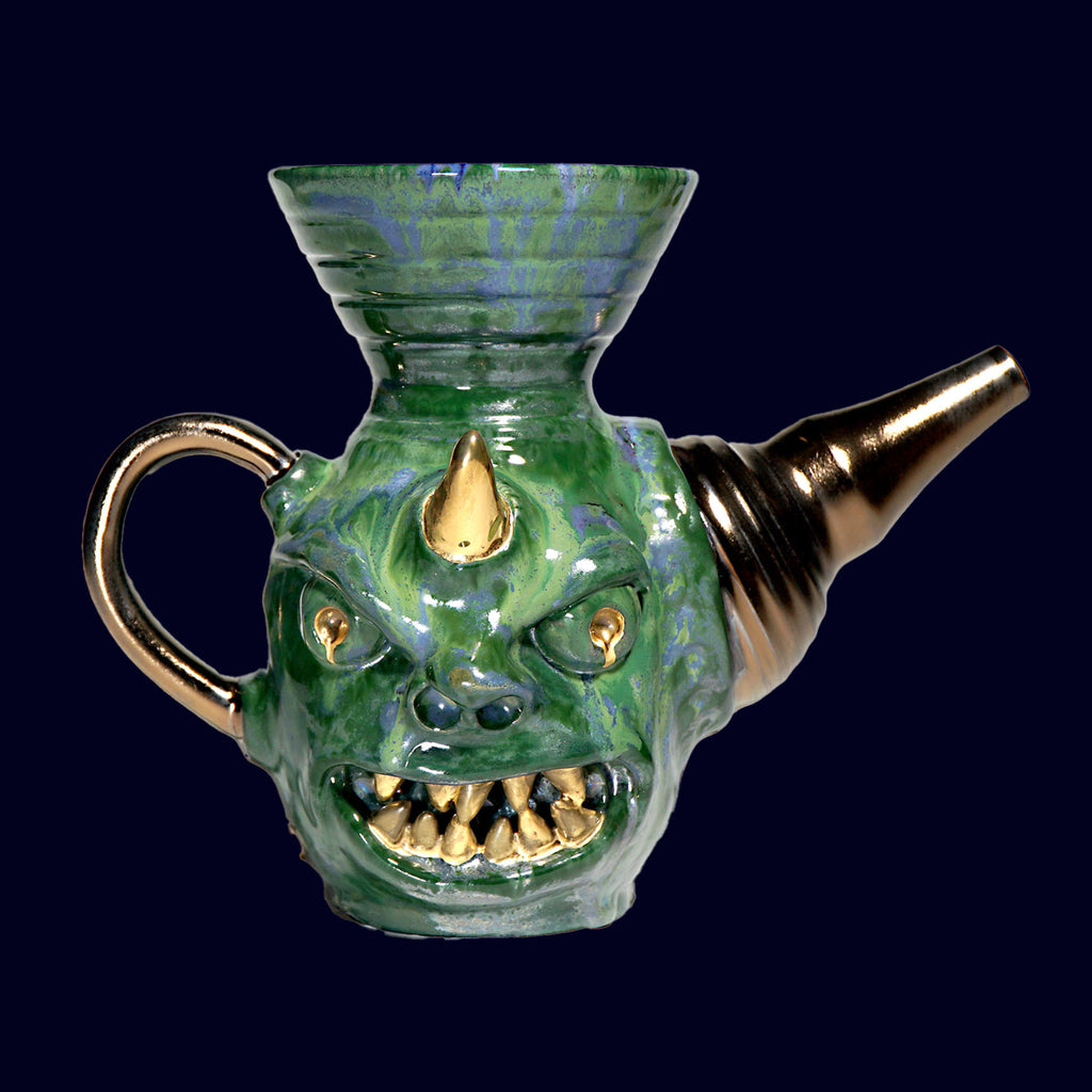 dogabi coffee hand dripper in porcelain. looks like a goblin with round eyes and gold teeth monster face top