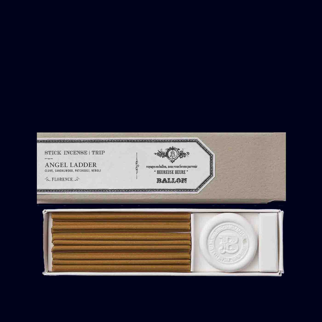 Incense sticks in a box with a visible brand logo on a black background