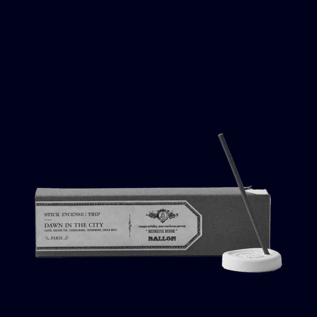 Incense stick with packaging labeled 'Dawn in the City' on a black background