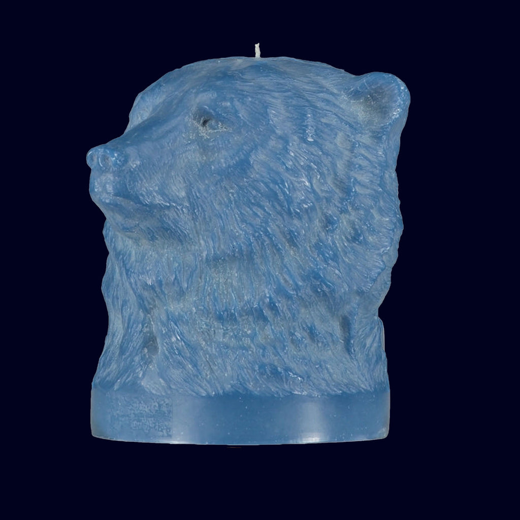 Blue candle shaped like a lion's head on a black background