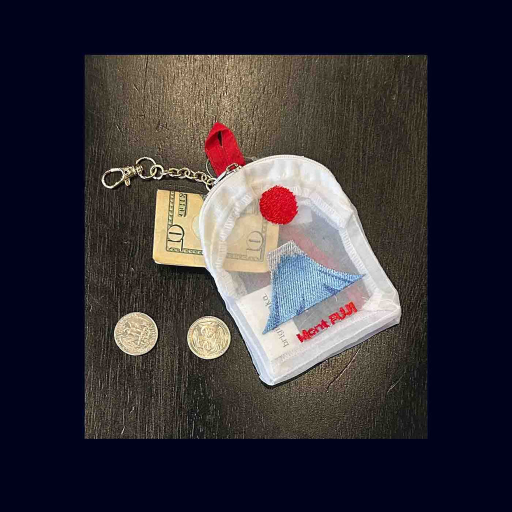 Small pouch with money and coins on a wooden surface