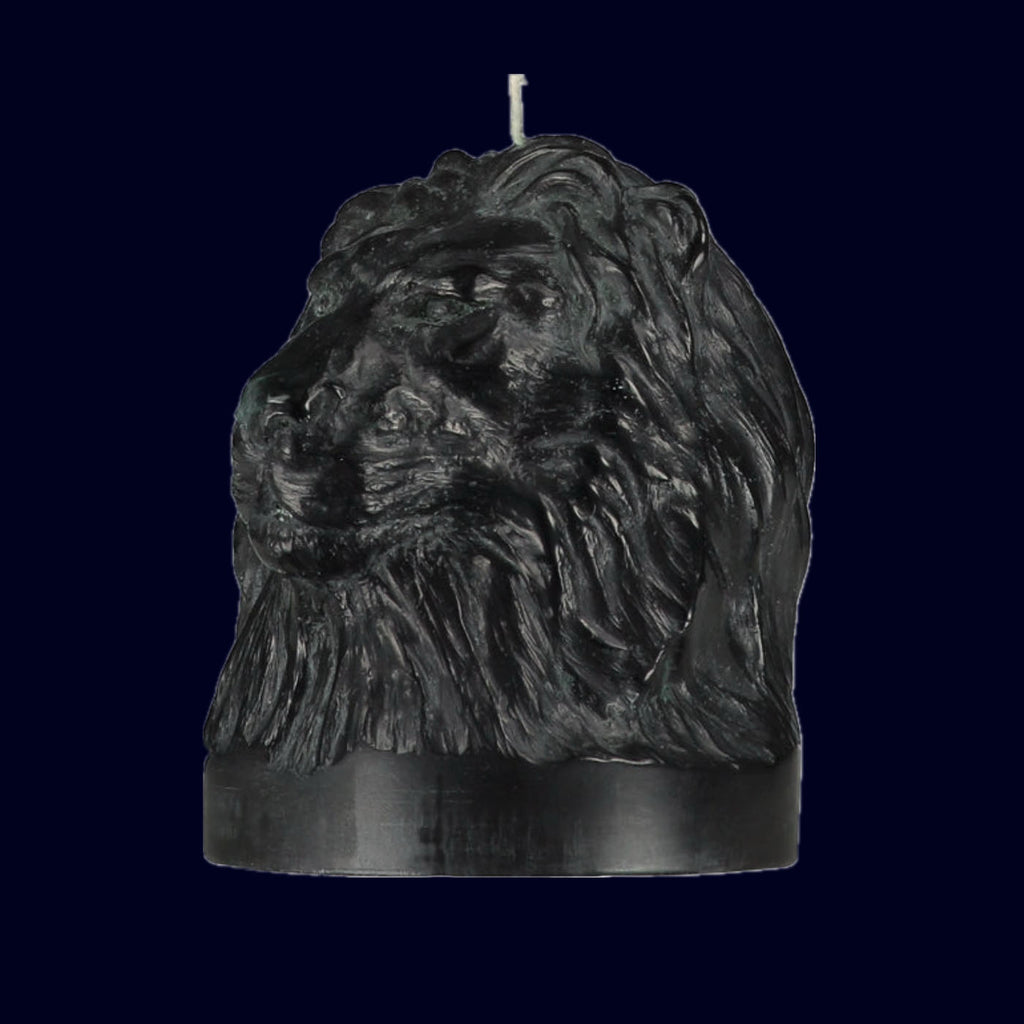 Black candle shaped like a lion's head on a white background