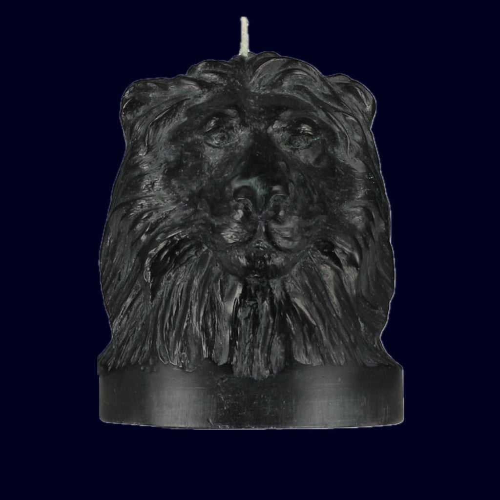 Black candle shaped like a lion's head on a black background