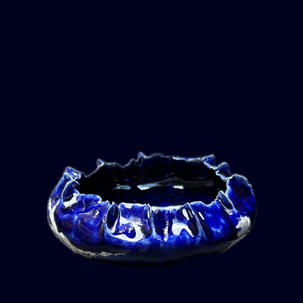 Blue ceramic dish on a black background