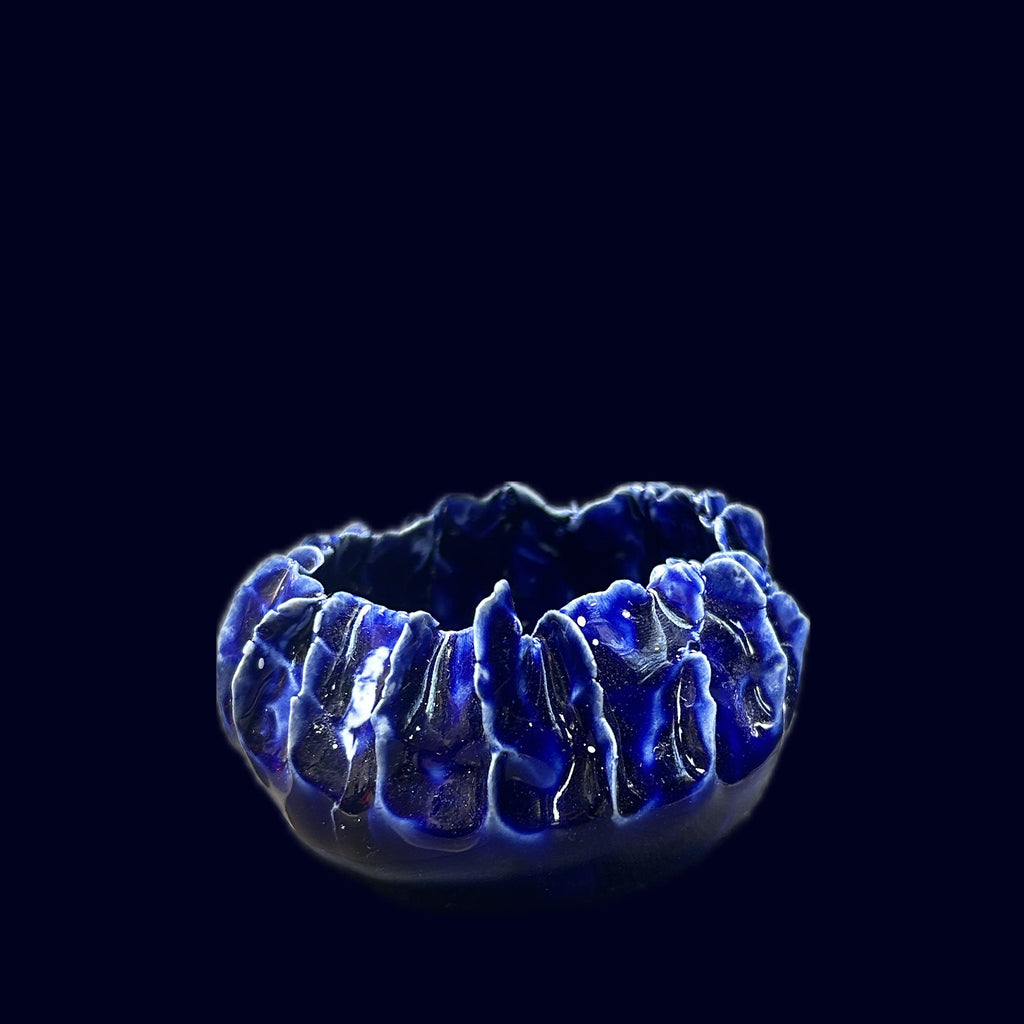 Blue ceramic bowl on a black background