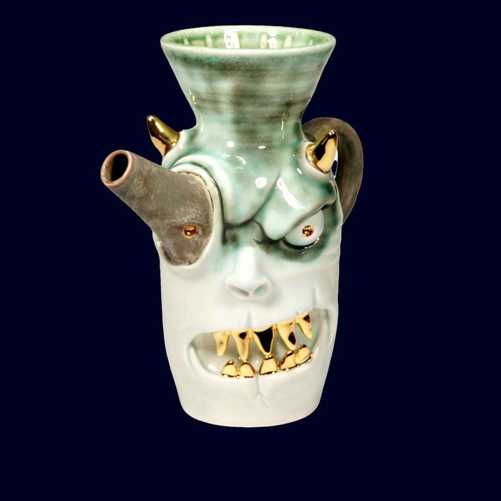 DOGABI Ceramic coffee hand dripper designed like a face with gold accents on a dark background