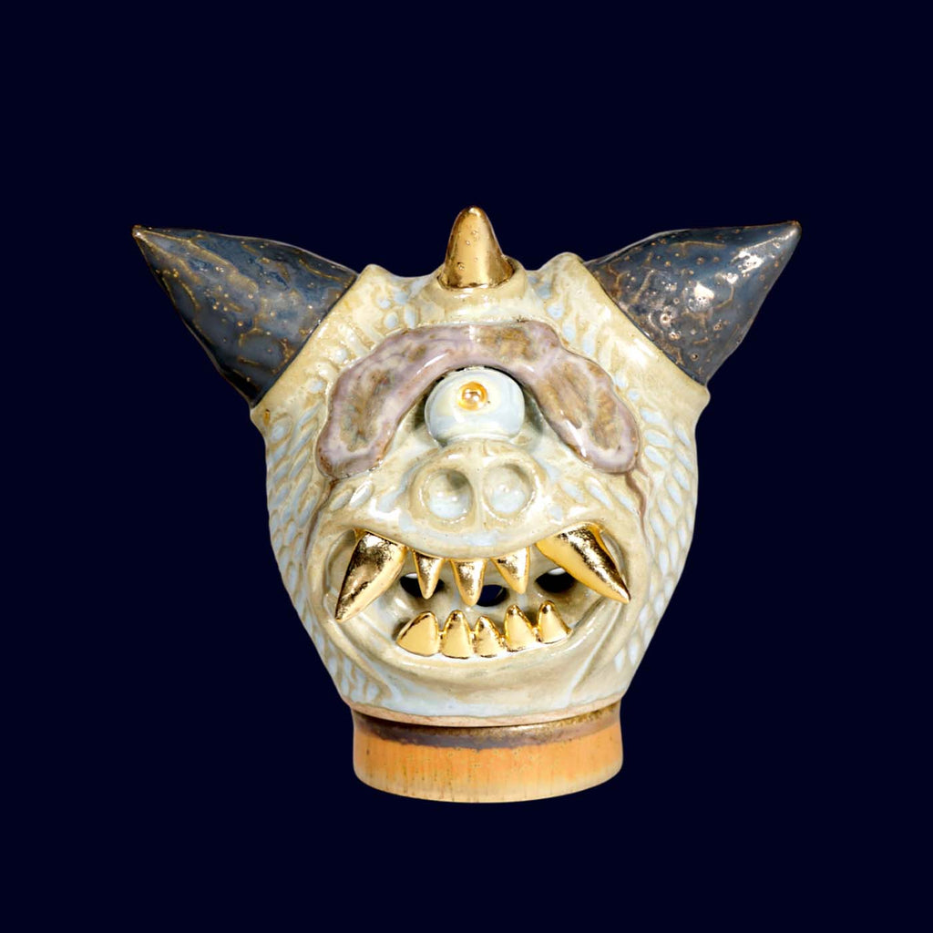 Ceramic dragon head incense burner on a dark background