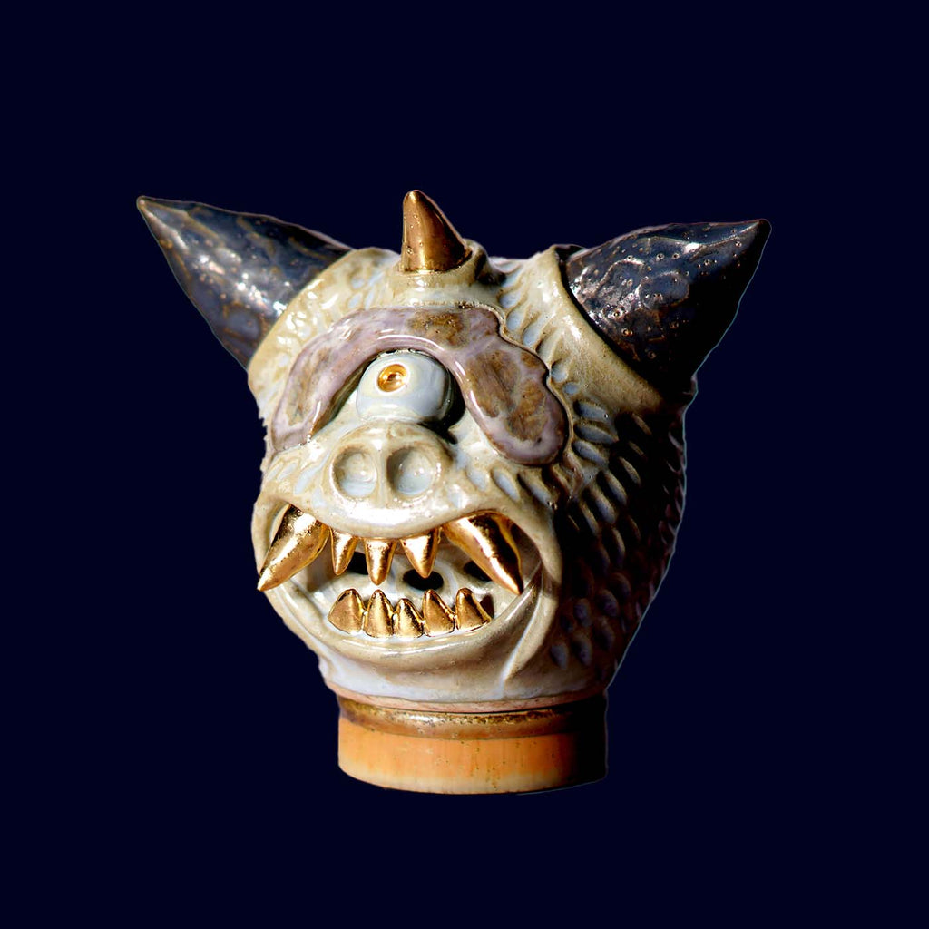 Ceramic dragon head incense burner on a dark background