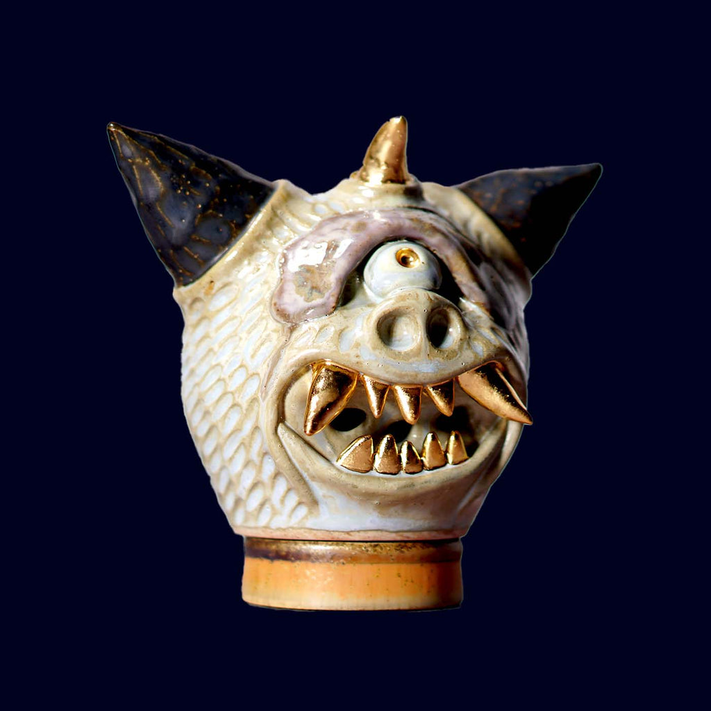 Ceramic dragon head incense burner on a dark background