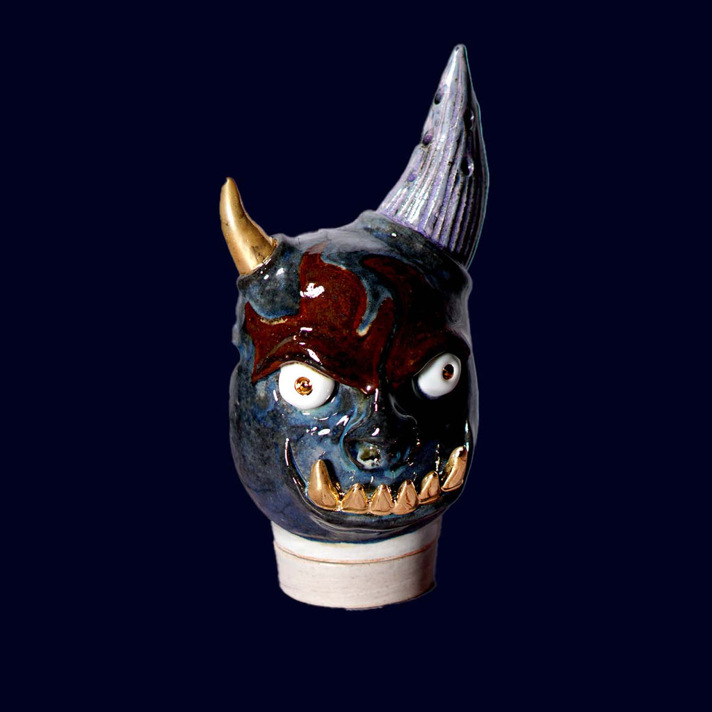 Ceramic incense burner with blue face, gold horn, and grey horn
