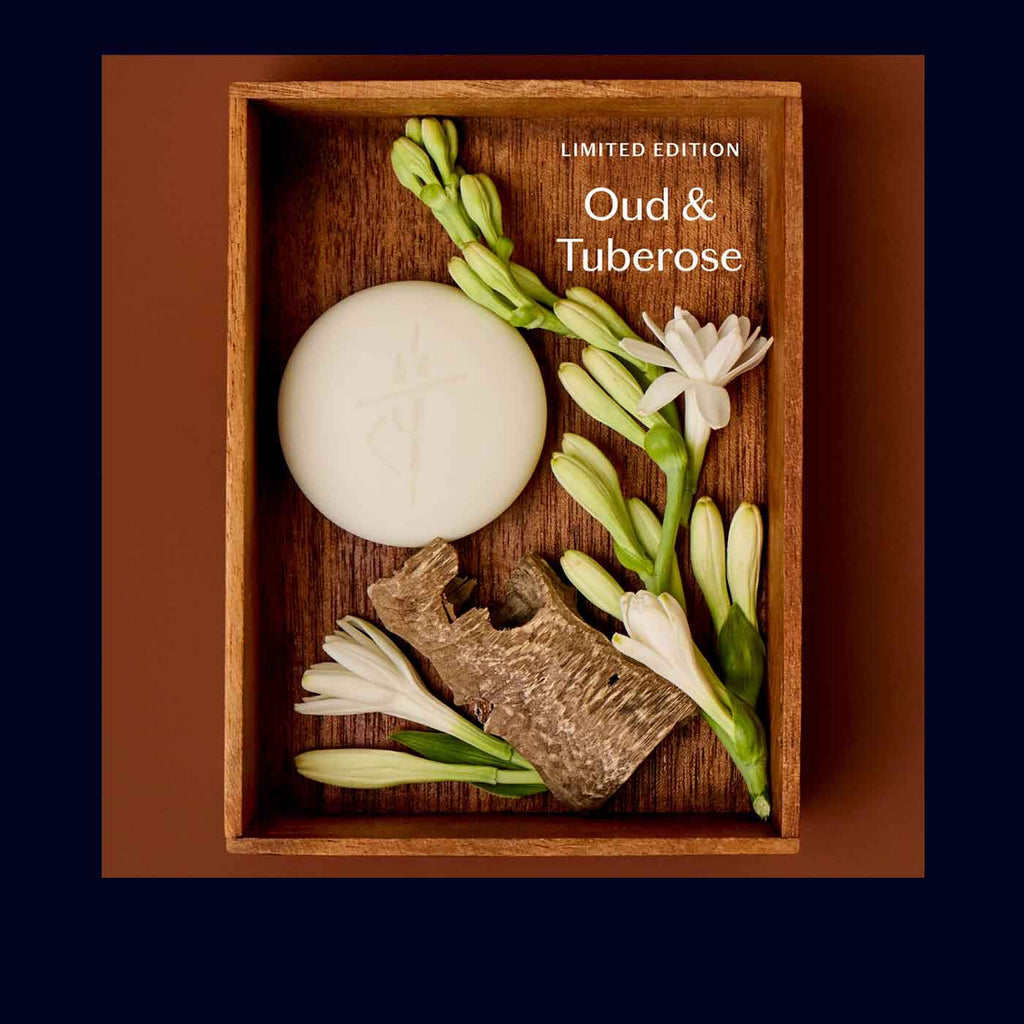 Soap with flowers and incense in a wooden box labeled 'Oud & Tuberose'.