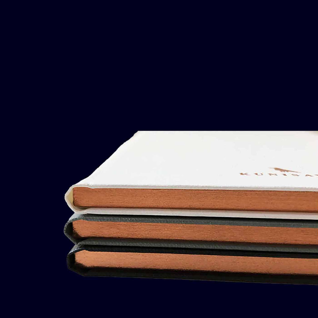 Stack of KUNISAWA notebooks WITH GOLD EDGES