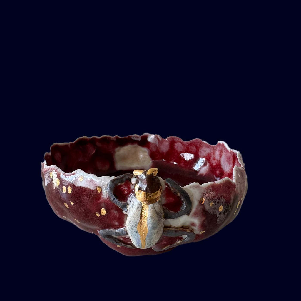 Decorative ceramic bowl with a butterfly design on a black background