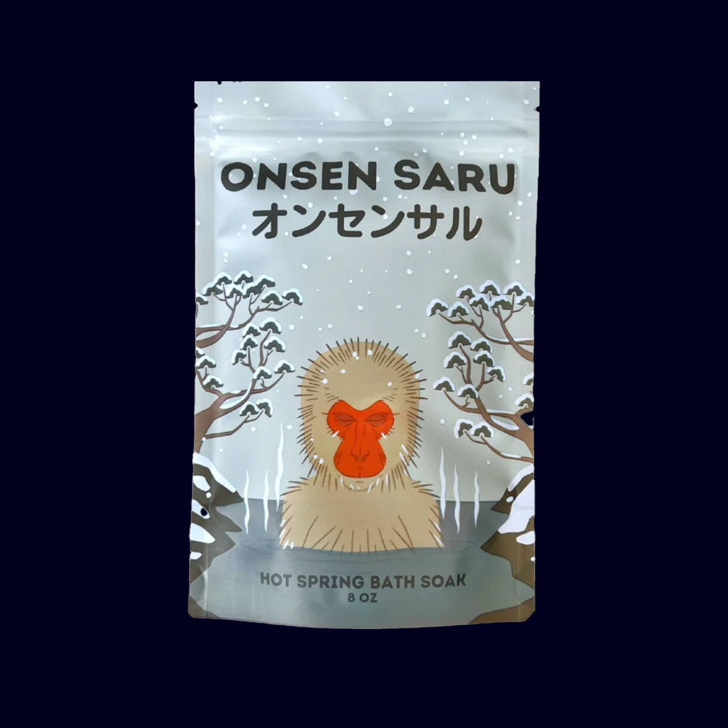 onsen saru japanese magnesium bath salts in a pouch. label has a drawing of a monkey in a hot spring