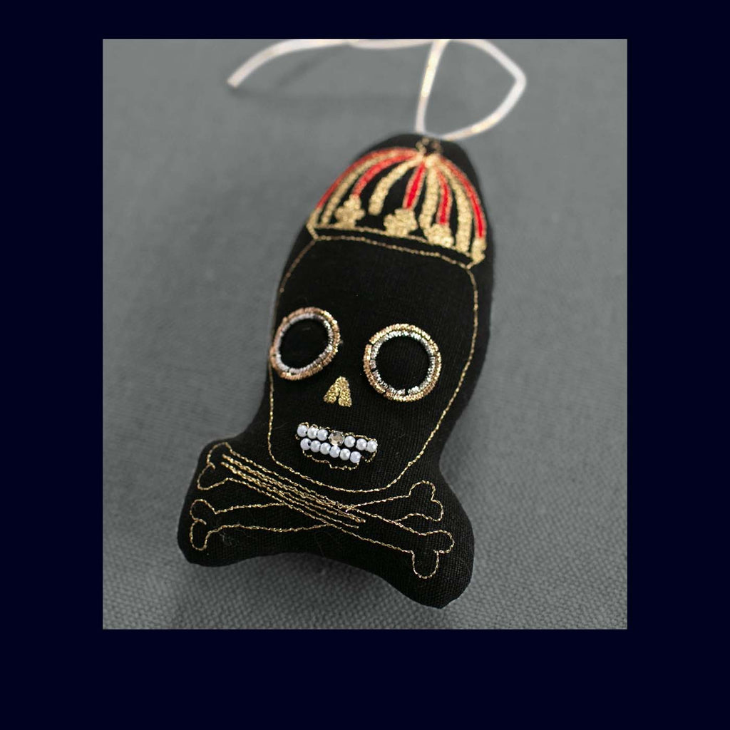 Decorative skull ornament with a crown on a gray background