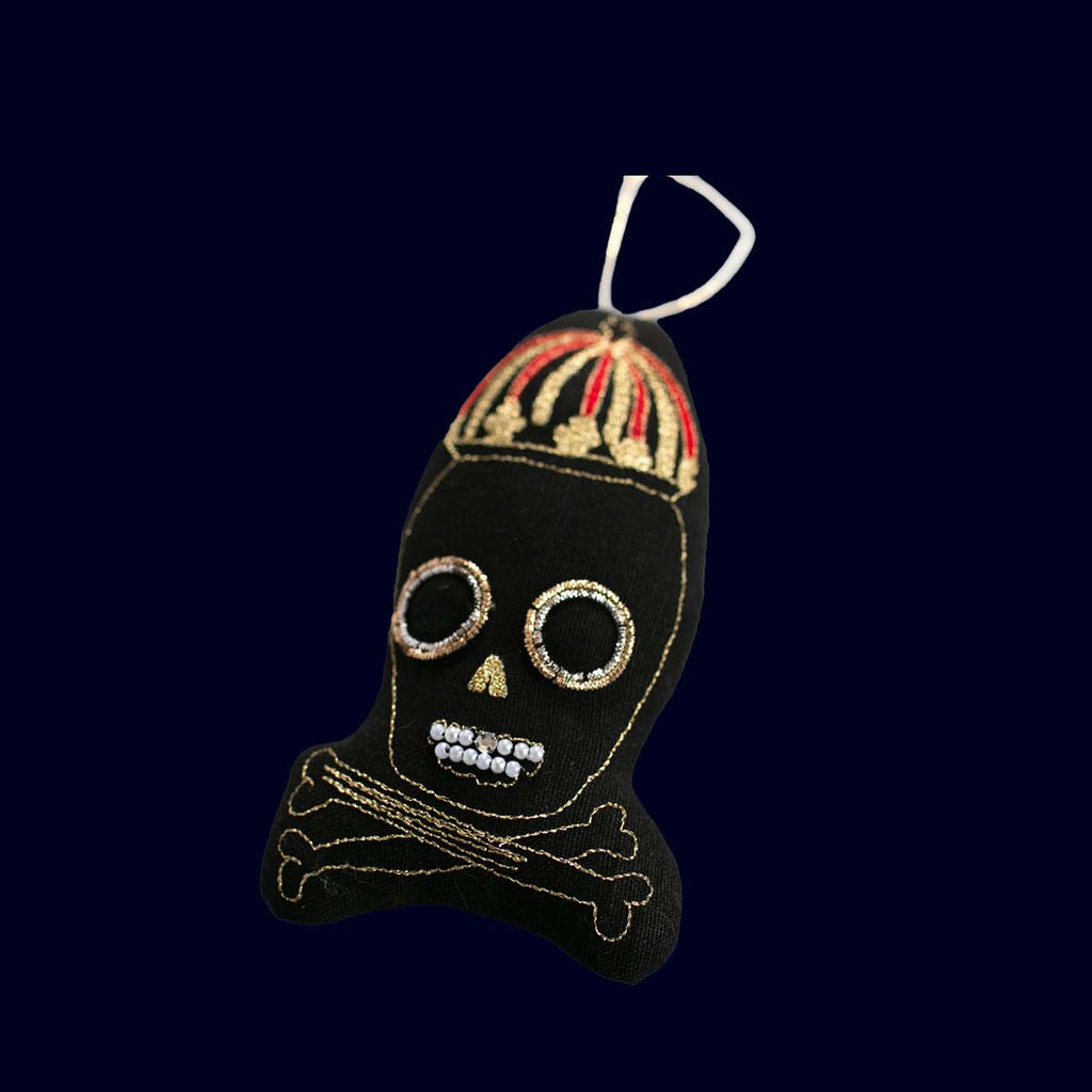 Decorative skull ornament with a colorful hat on a black background