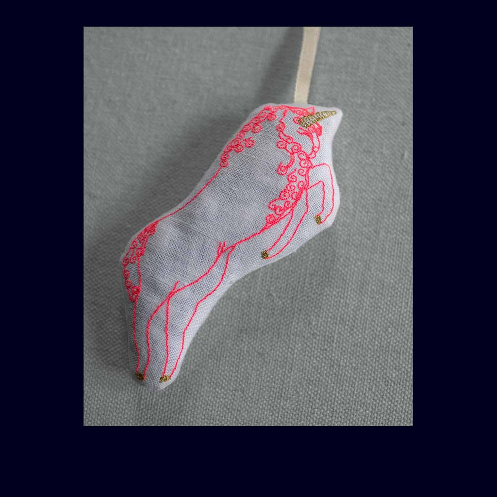 Decorative item with embroidered design on a gray background