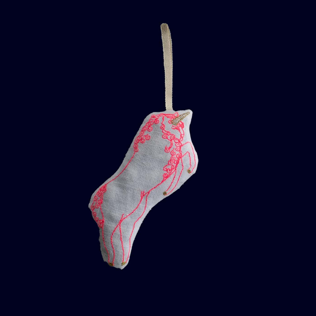 Decorative sachet with red lace pattern on a dark background