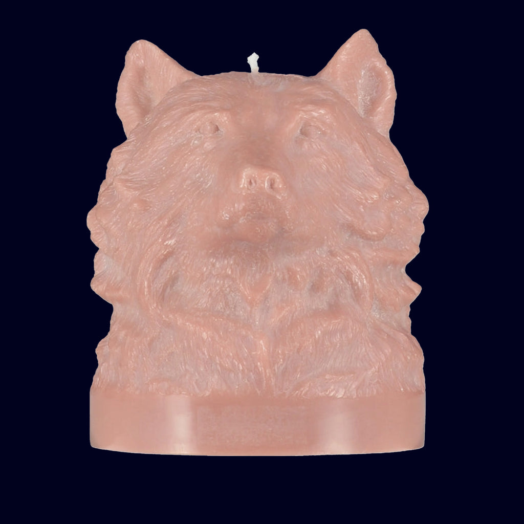 Candle shaped like a wolf head on a black background