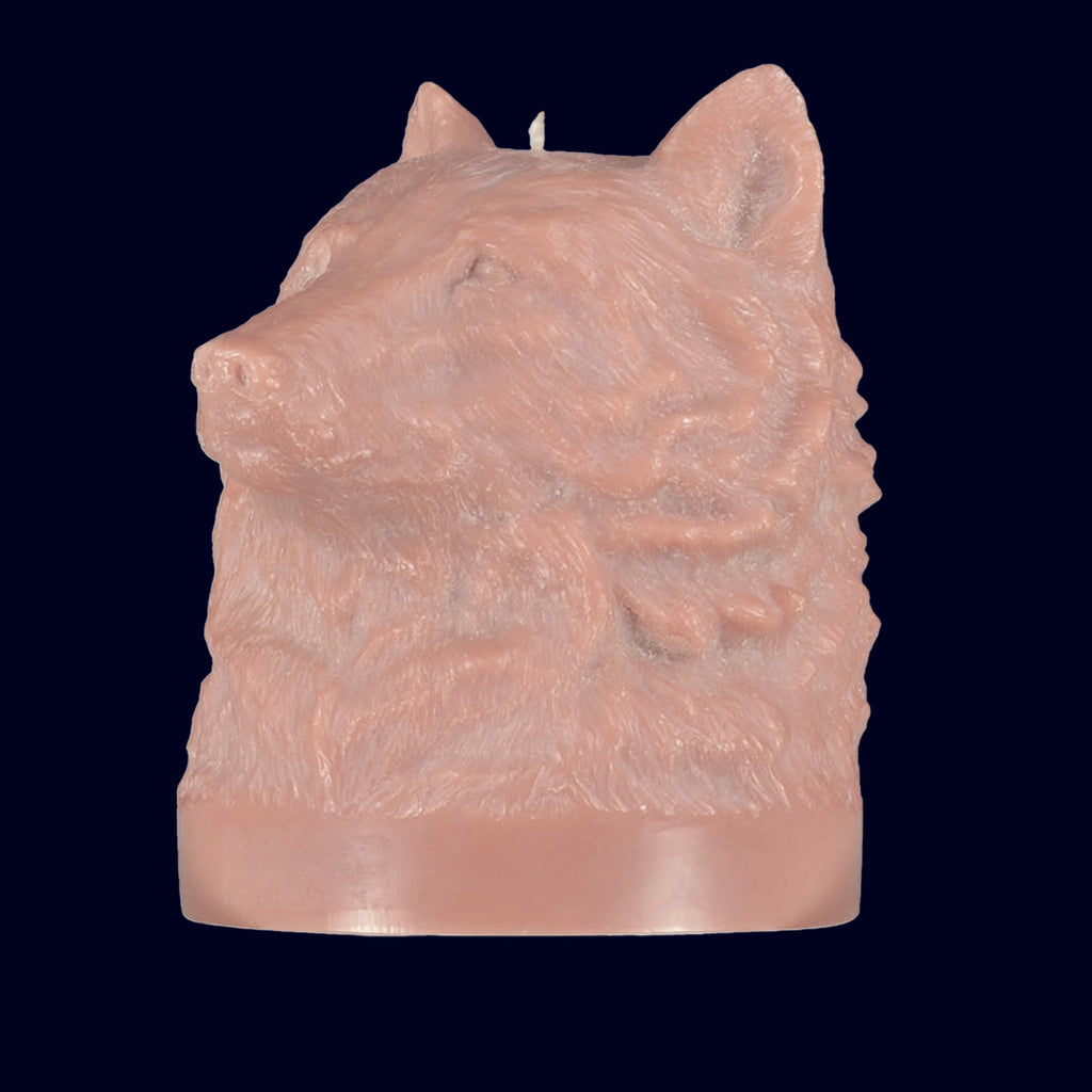 Candle shaped like a wolf head on a black background