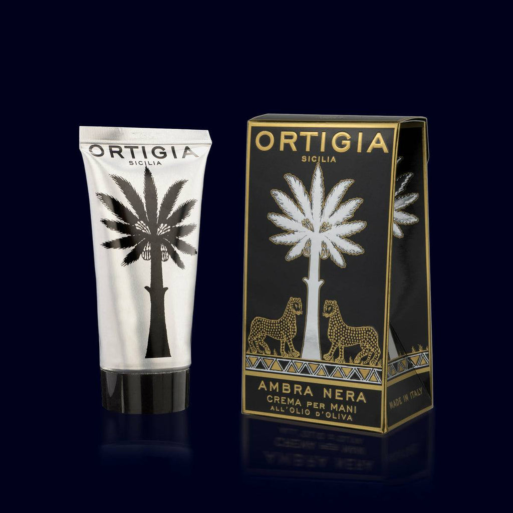ortigia hand cream in a silver tube and black, gold and silver box. ambra nera-amber