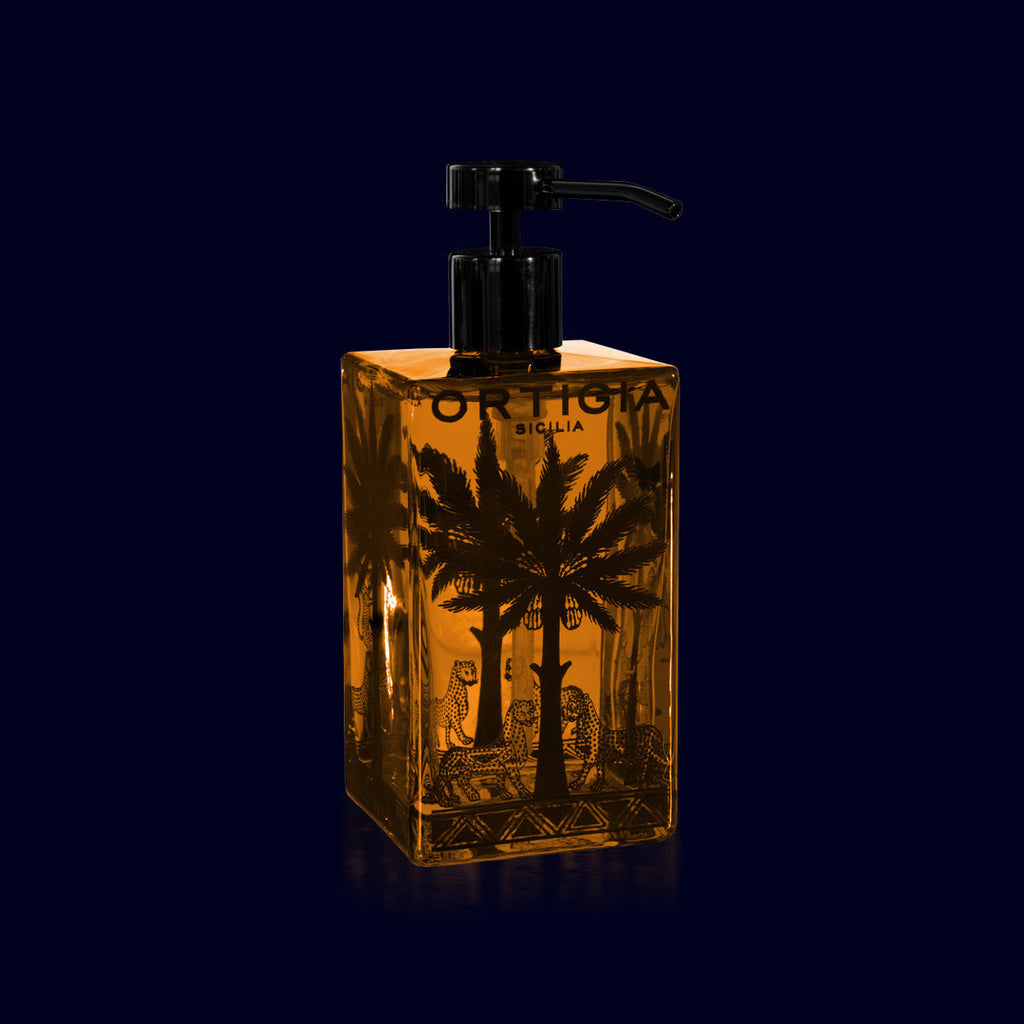 ortigia liquid soap in a glass bottle decorated with palm trees. ambra nera-amber